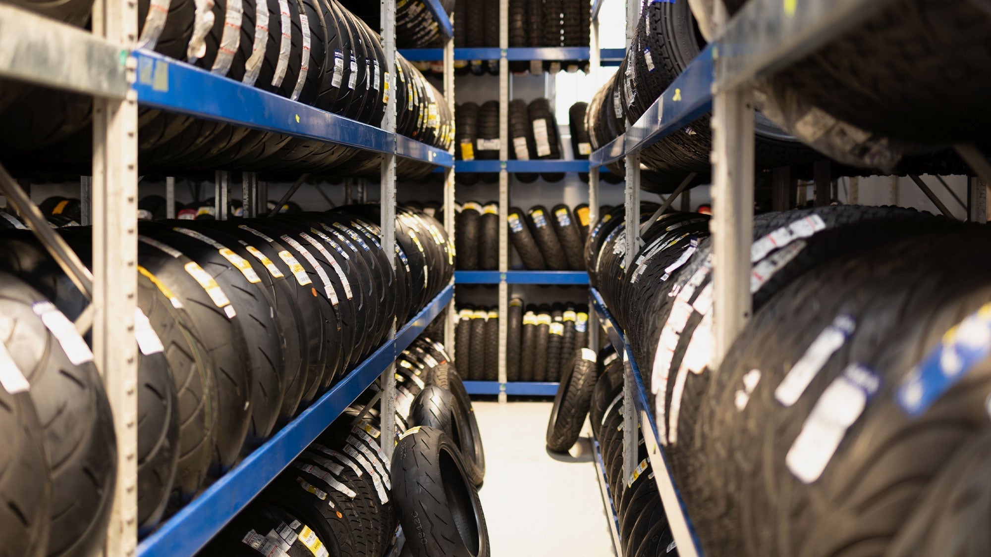 Rows of motorcycle tyres on racks at Cycletreads Takapuna, Auckland